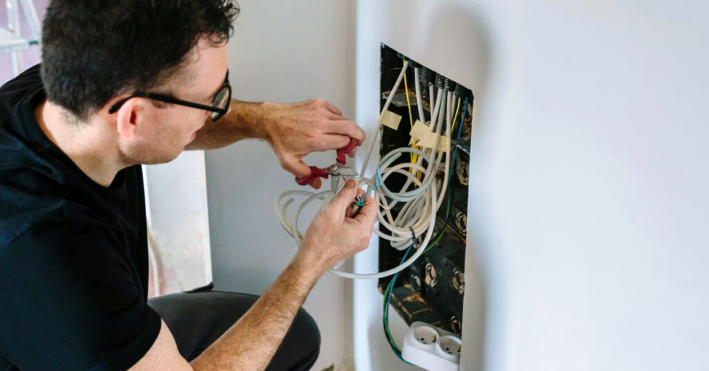 Male working on cables for fibre to the home